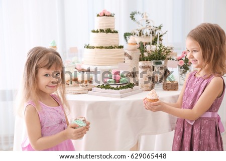 Cute girls with sweets at party
