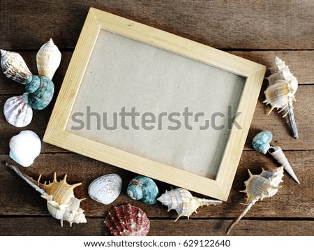 frame for a photo in a marine style on wooden background summer concept