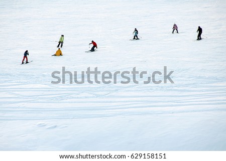 A group of people skiing on snow.