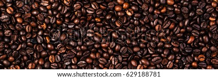 Coffee beans background macro. Dark Roasted coffee beans textured wallpaper for your design with copy space
