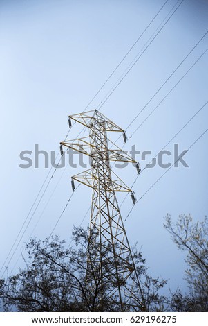 A large electric pole standing tall