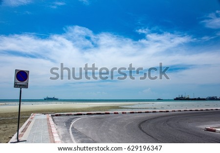 Beautiful landscape pictures of seafront road with blue sky and white cloud in summer/Non-English language means no parking.