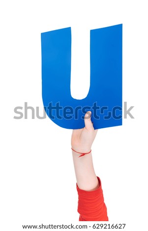 Kid holding colorful alphabet letter U in hand isolated, alphabet letters concept