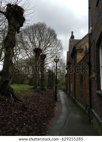 The graveyard walkway at the back of St Mary’s Church, Warwick, West Midlands, United Kingdom, Europe. The picture was taken in February 2016.