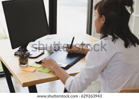 freelance artist graphic designer drawing on digital tablet. young woman working with color swatch palette catalog samples for selection - Creativity Editor Ideas Concept