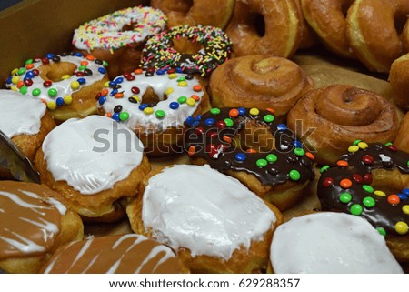 colorful rows of topped and filled donuts 2