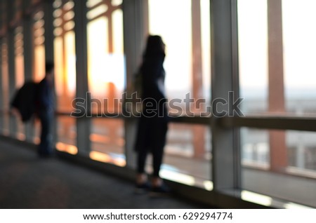 woman is waiting in airport blur background