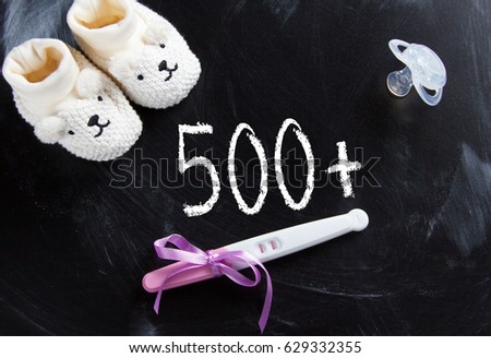 Social policy in Poland "500+" on black chalkboard with positive pregnancy test Royalty-Free Stock Photo #629332355