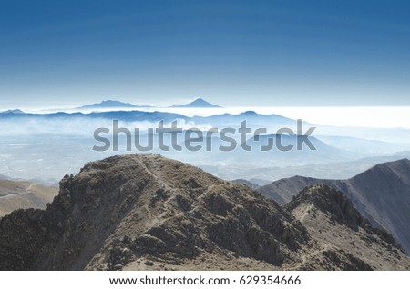 Amazing landscape of mountains over the clouds