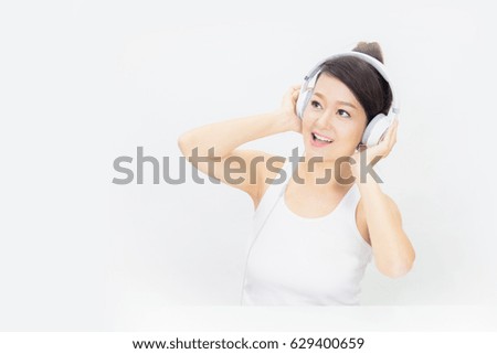 Young woman relaxing and listening to music with headphones.