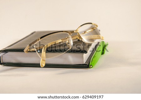 Notepad, pen and glasses for vision