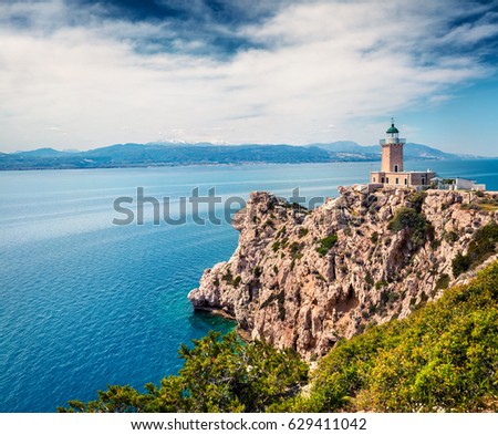 Bright sunny view of Melagavi lighthouse in the Corinth Gulf. Picturesque spring seascape in the Greece, Europe. Beauty of nature concept background. Artistic style post processed photo.
