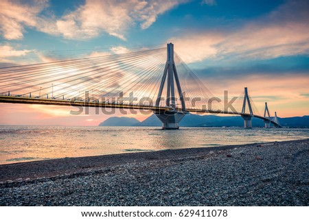 Dramatic evening scene with Rion-Antirion Bridge. Colorful spring scene of the Gulf of Corinth, Greece, Europe. Beauty of countryside concept background. Artistic style post processed photo.
