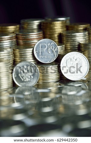 coins with symbols of ruble and eagle on the stacks of coins