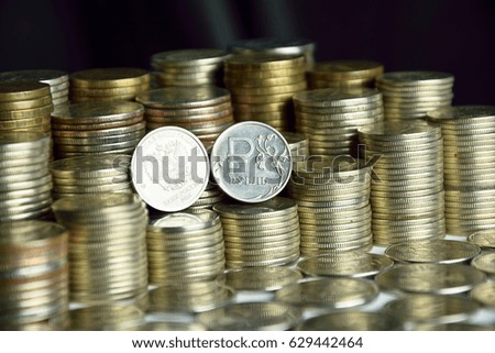 coins with symbols of ruble and eagle on the stacks of coins