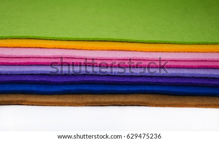 Several colorful pieces of felt are piled up