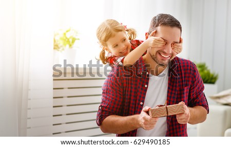 Father's day. Happy family daughter hugging dad and laughs on holiday Royalty-Free Stock Photo #629490185