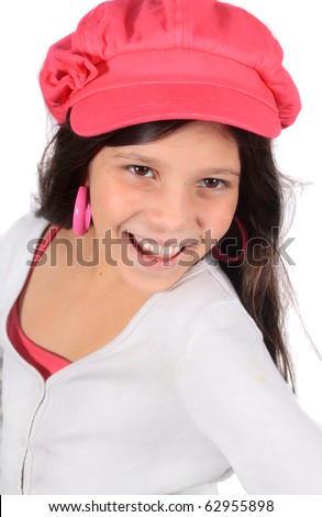 Pretty eight year old adolescent multi ethnic girl with windswept long dark hair on a white background wearing colorful pink hat