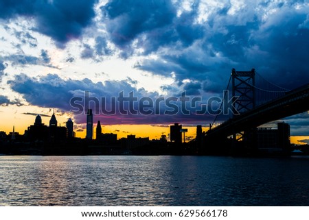 sunset skyline of philadelphia pennsylvania from camden new jersey with benjamin franklin bridge