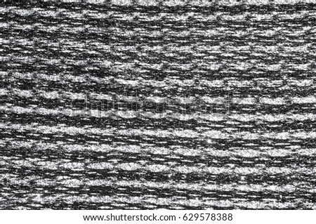 Texture, background, pattern. Women's scarf, striped fabric Black white lines intertwined