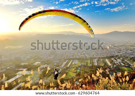 paraglider flying on sunset