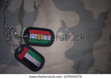 army blank, dog tag with flag of kurdistan and united arab emirates on the khaki texture background. military concept
