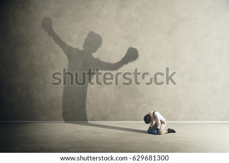 man defeated by his shadow boxing Royalty-Free Stock Photo #629681300