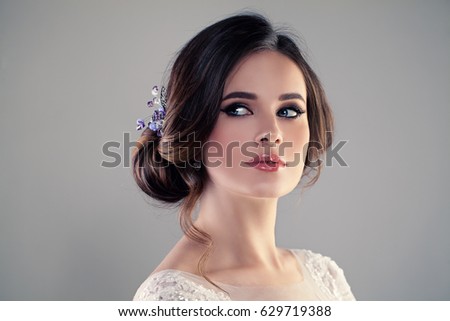 Beautiful Bride with Wedding Hairstyle and Make up. Studio Portrait of Young Gorgeous Bride. Perfect Fiancee