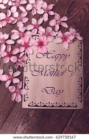 Postcard with peach blossoms on a wooden vintage table 