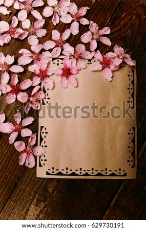 writing retro card whis peach blossoms on a wooden vintage table
