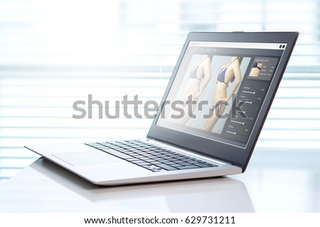 Image manipulation software in a laptop in office. Transforming girl skinnier and slim for marketing or advertisement. Photo editing and beauty standards concept.