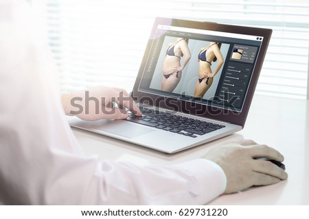 Photo editing with laptop and software. Retouching a photo of a girl in underwear for marketing or advertisement. Heavy image post processing and beauty standards concept.