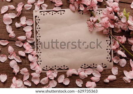 writing retro card whis peach blossoms on a wooden vintage table