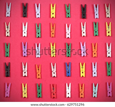 Clothespins bright little different color lie on the table 