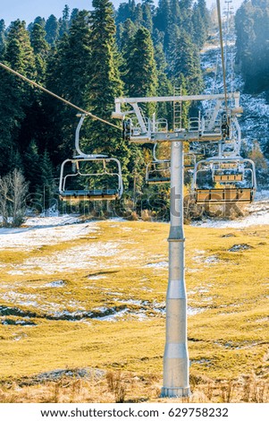 Empty cableway on the background of the  mountains and autumn forest
