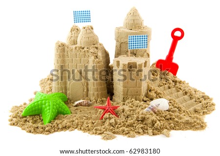 Sandcastle at the beach on vacation isolated over white