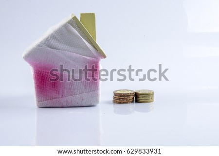 House and little coins. Deficiency saving concept