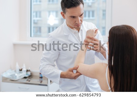 Nice male doctor holding his patients hand Royalty-Free Stock Photo #629854793