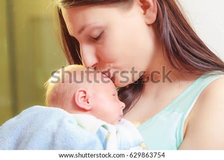 Beauty of parenting, motherhood love concept. Mother holding her little newborn baby