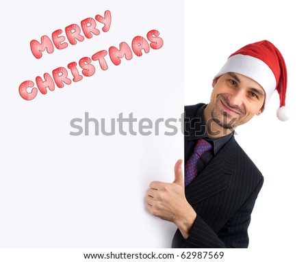 Christmas concept. Young businessman holding blank white card.