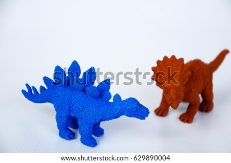 Triceratops and Stegosaurus dinosaur model made from brown rubber isolated on white background.  
