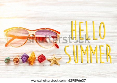 hello summer text, travel vacation concept, space for text, flat lay. sunglasses and colorful shells starfish on white wooden background top view. holiday. wanderlust.