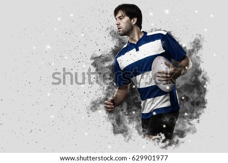 Rugby Player with a blue uniform coming out of a blast of smoke .