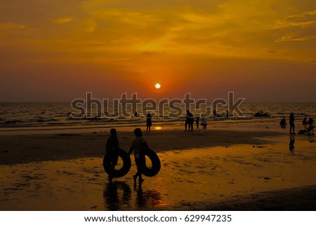 Beautiful blazing sunset landscape at black sea and orange sky above it with awesome sun golden reflection on calm waves as a background. Amazing summer sunset view on the beach.