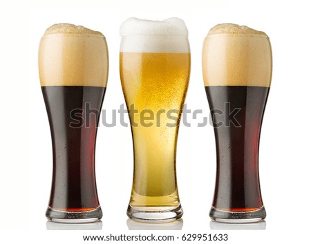 Glasses of beer over a white background