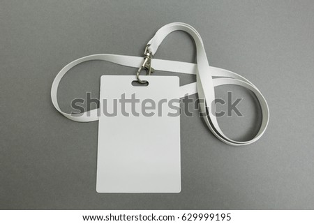 Businessman name card on a lanyard. Identification tag isolated on gray background. Blank ID card.