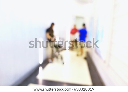Abstract blurred people walking sitting standing on walkway path airport with white wall