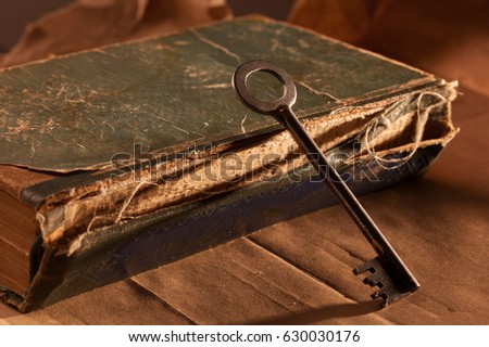 Vintage book and the key. Concept photo.