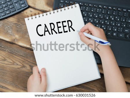 Hands with pen writing career plan on notebook at home or office. (calculator)