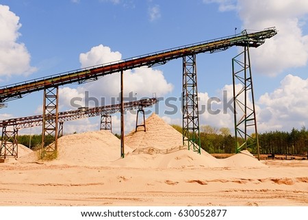 Conveyor belts and sand heaps. Construction industry. Sand quarry. Horizontal  photo.